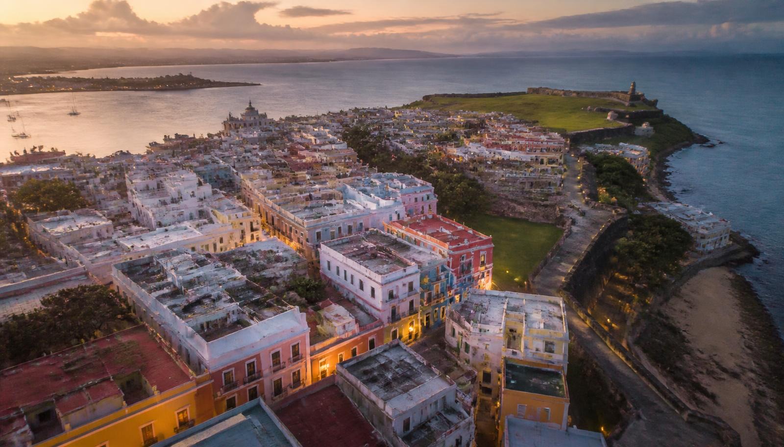 Aerial view of Old San Juan rooftops, the historic fort and the harbor